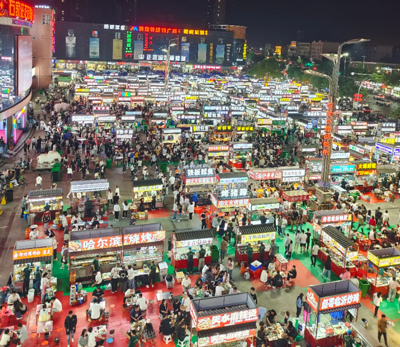 Busy, well-lit Shijiazhuang night market area for Hebei travel safety planning