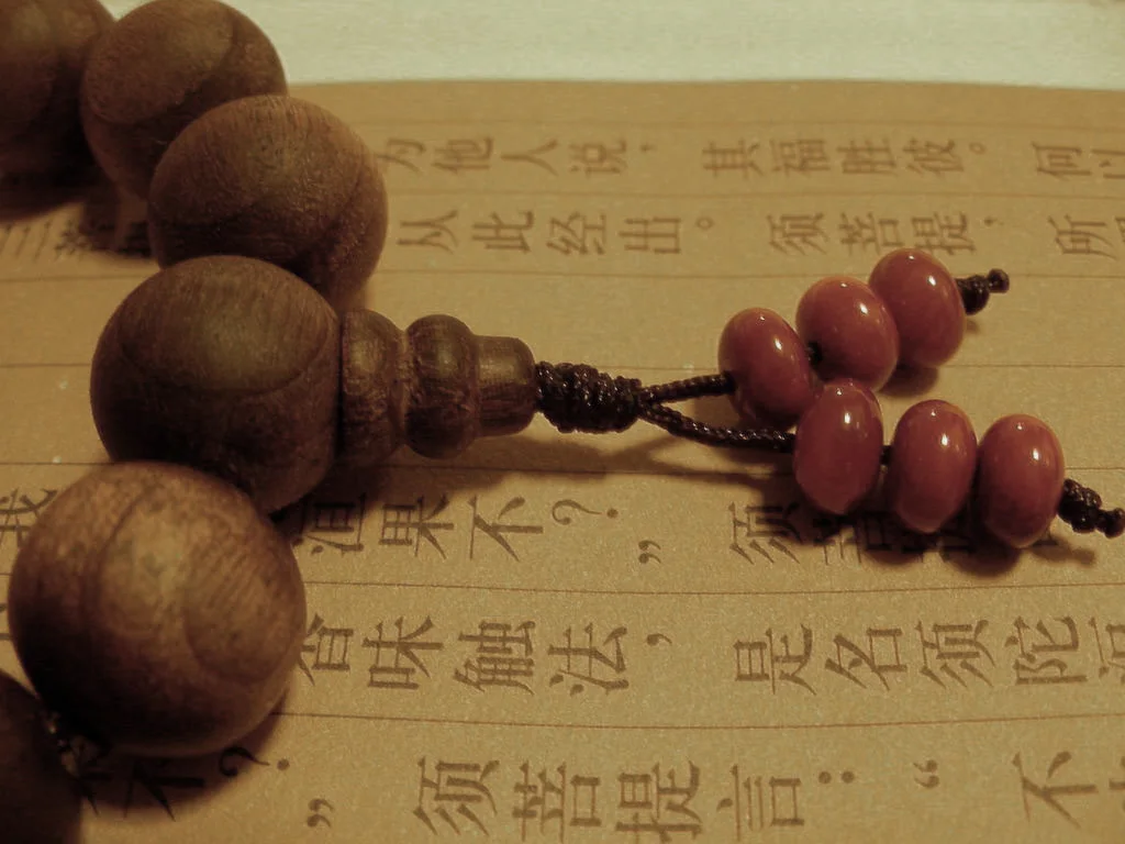 Buddhist beads and sutra detail for Bailin Temple travel context
