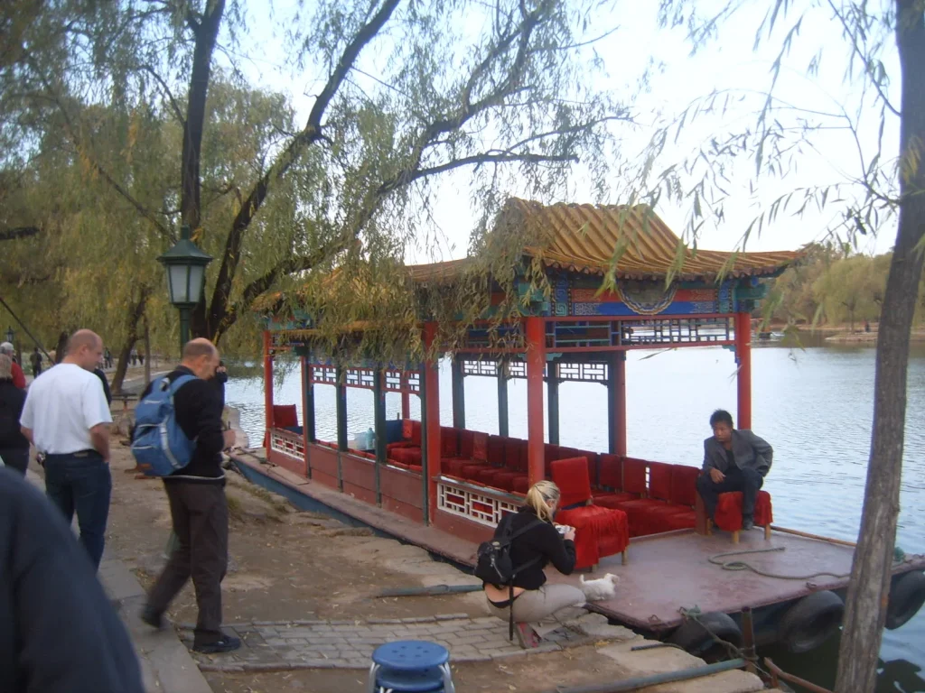Chengde Mountain Resort lake area with a pleasure boat and visitors