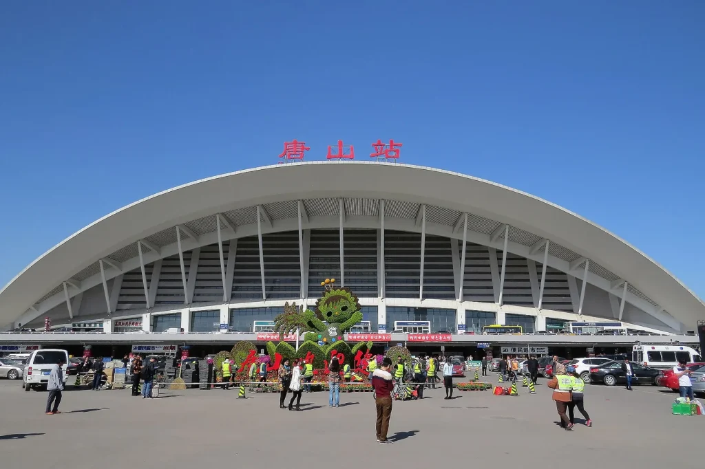 Tangshan Railway Station exterior with passengers outside the station