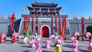 Wuqiao Acrobatics World performance area with performers and traditional gate in Cangzhou Hebei