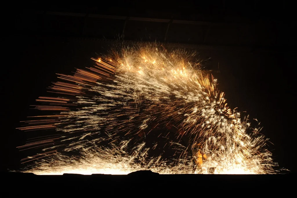 Burst of sparks from the controlled Dashuhua performance at Nuanquan Ancient Town