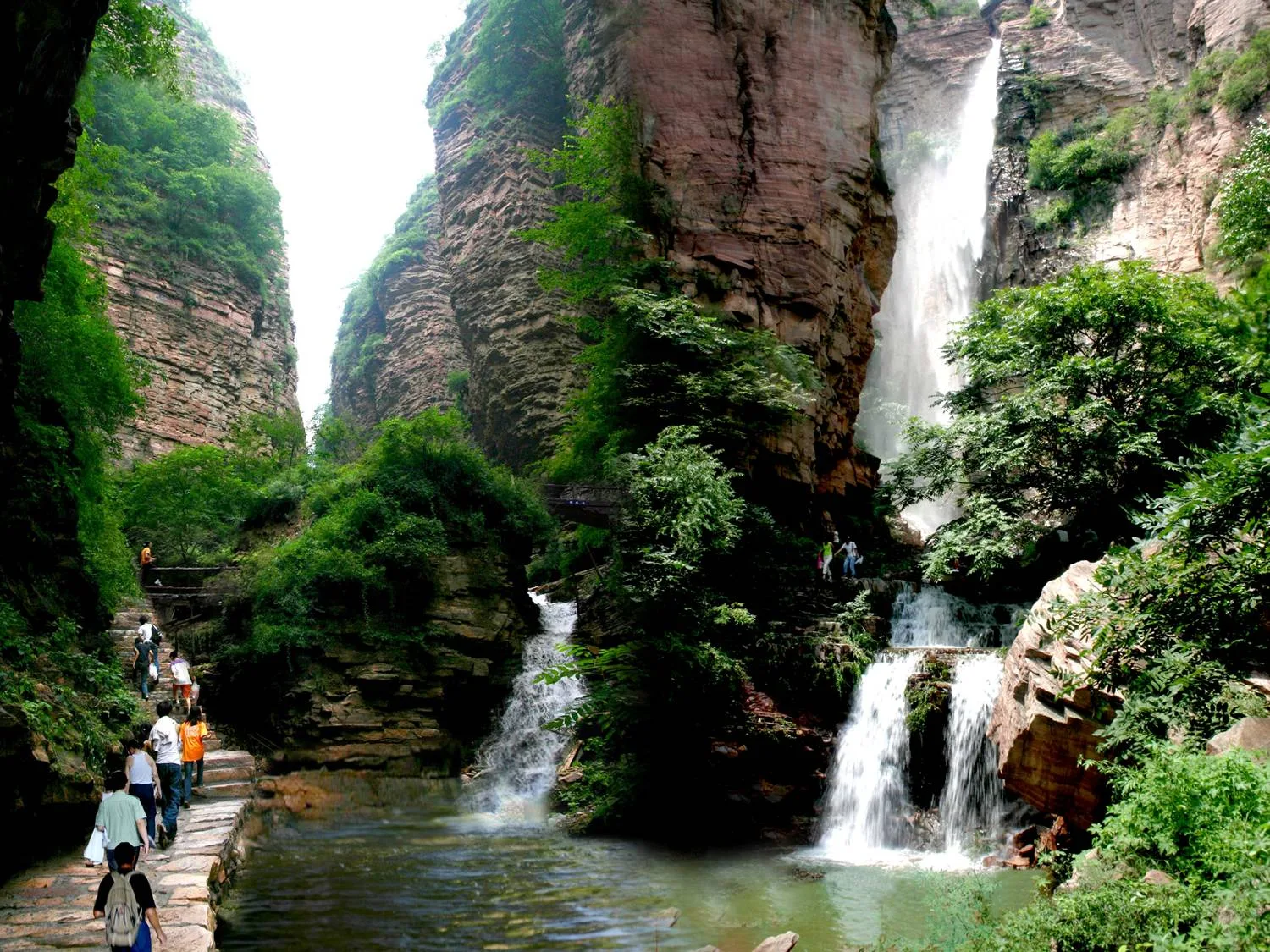 Waterfall and green sandstone walls in Xingtai Grand Canyon