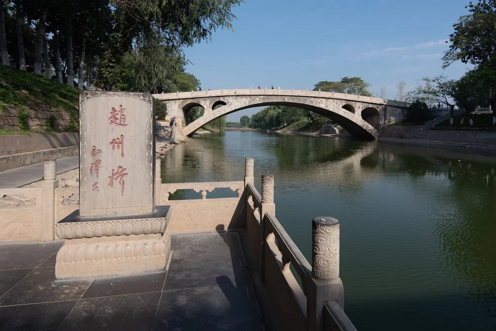 The stone arch of Zhaozhou Bridge reflected in the Xiao River in Zhao County