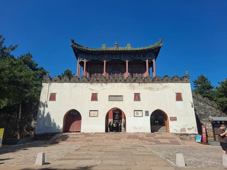 Real exterior view of Xumi Fushou Temple in Chengde showing the white terrace, arched entrances, and upper pavilion
