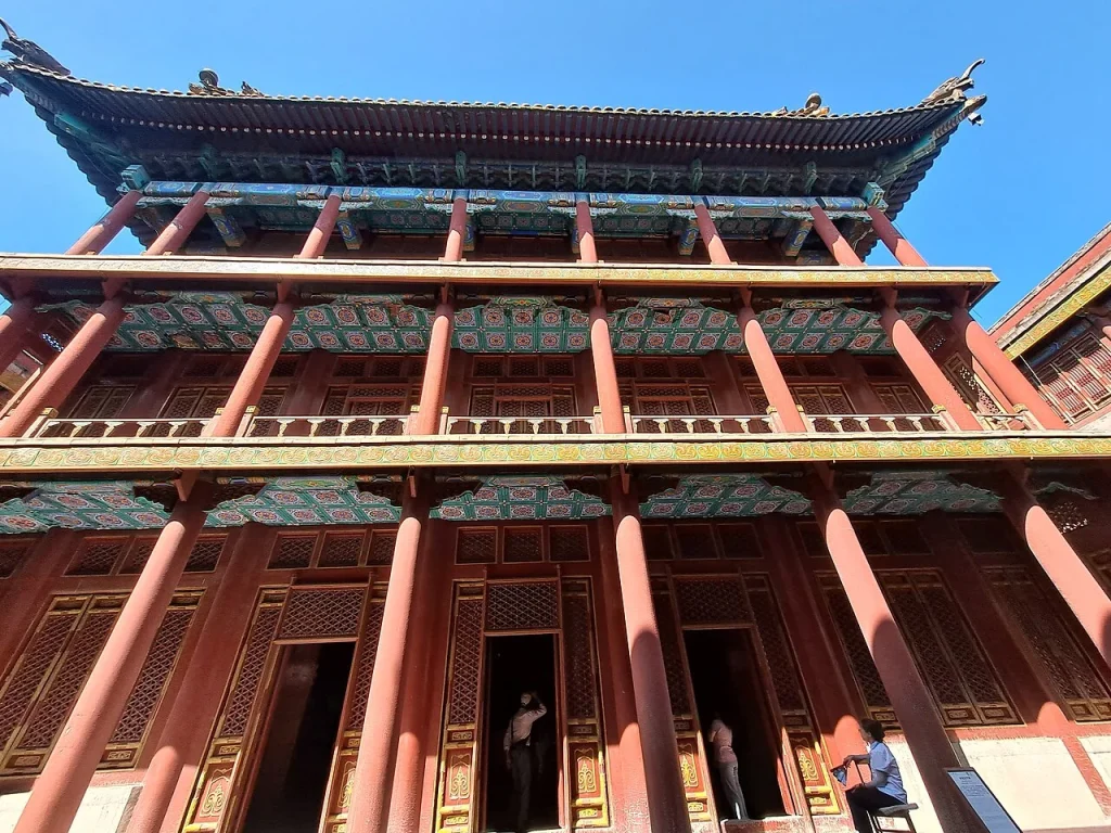 Real view looking up at a richly painted main-hall facade at Xumi Fushou Temple in Chengde