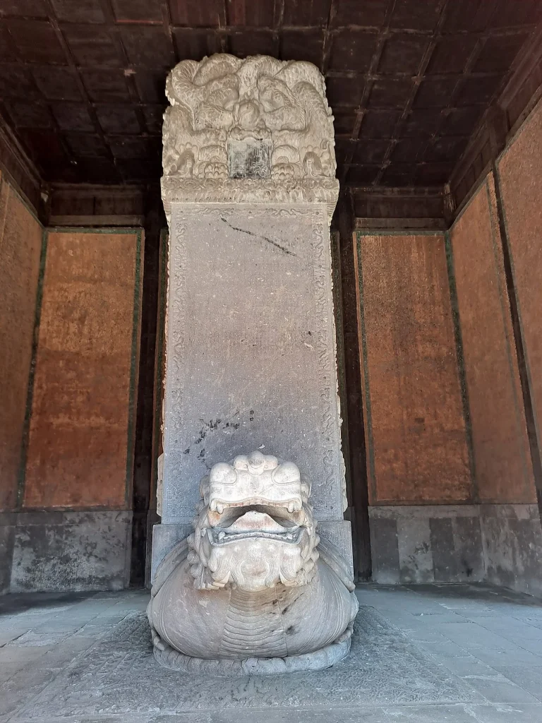 Real stone stele detail at Xumi Fushou Temple in Chengde, photographed in a covered architectural setting