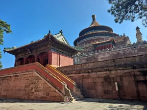 Circular tiled roof of Xuguang Pavilion above stone terraces and steps at Pule Temple in Chengde