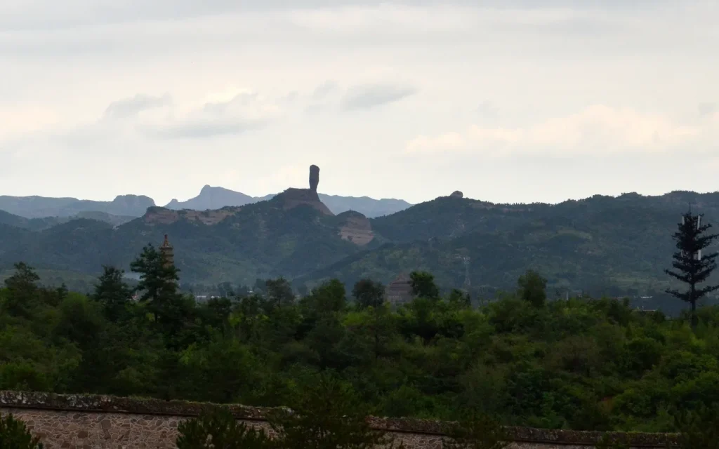 Qingchui Peak as a small silhouette across the Chengde hills