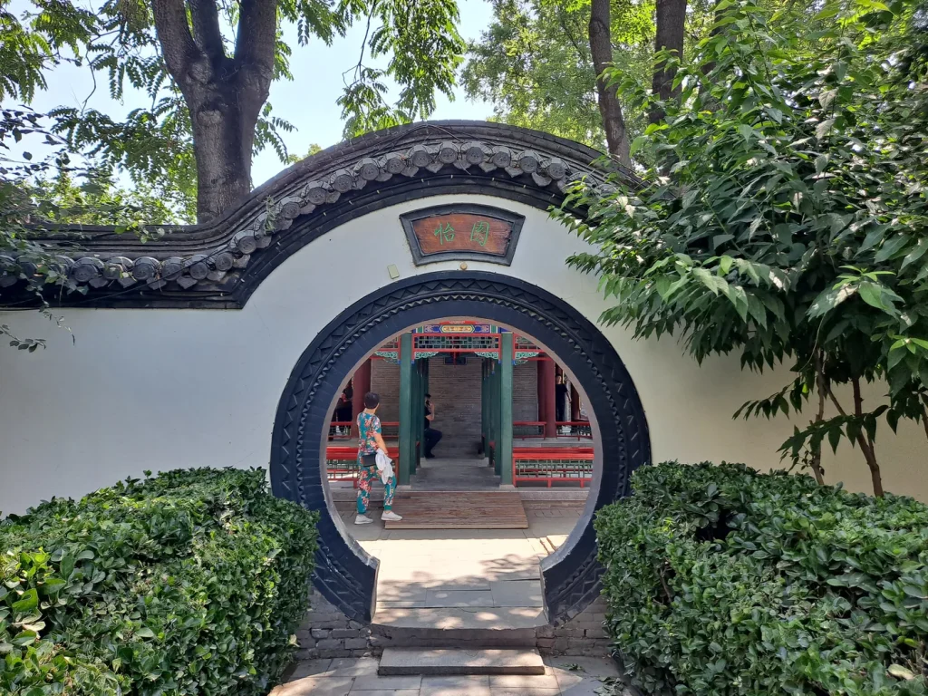 Round moon gate framing the garden at Rongguo Mansion