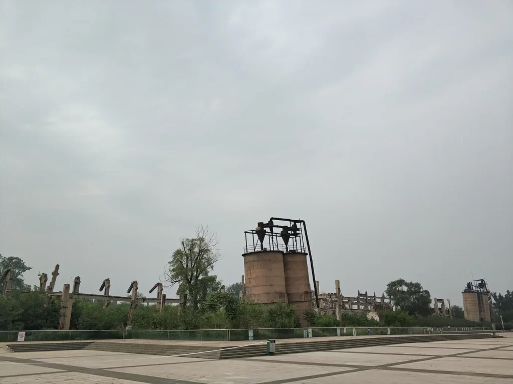 Damaged industrial structures preserved from the former Tangshan rolling-stock works inside the memorial park